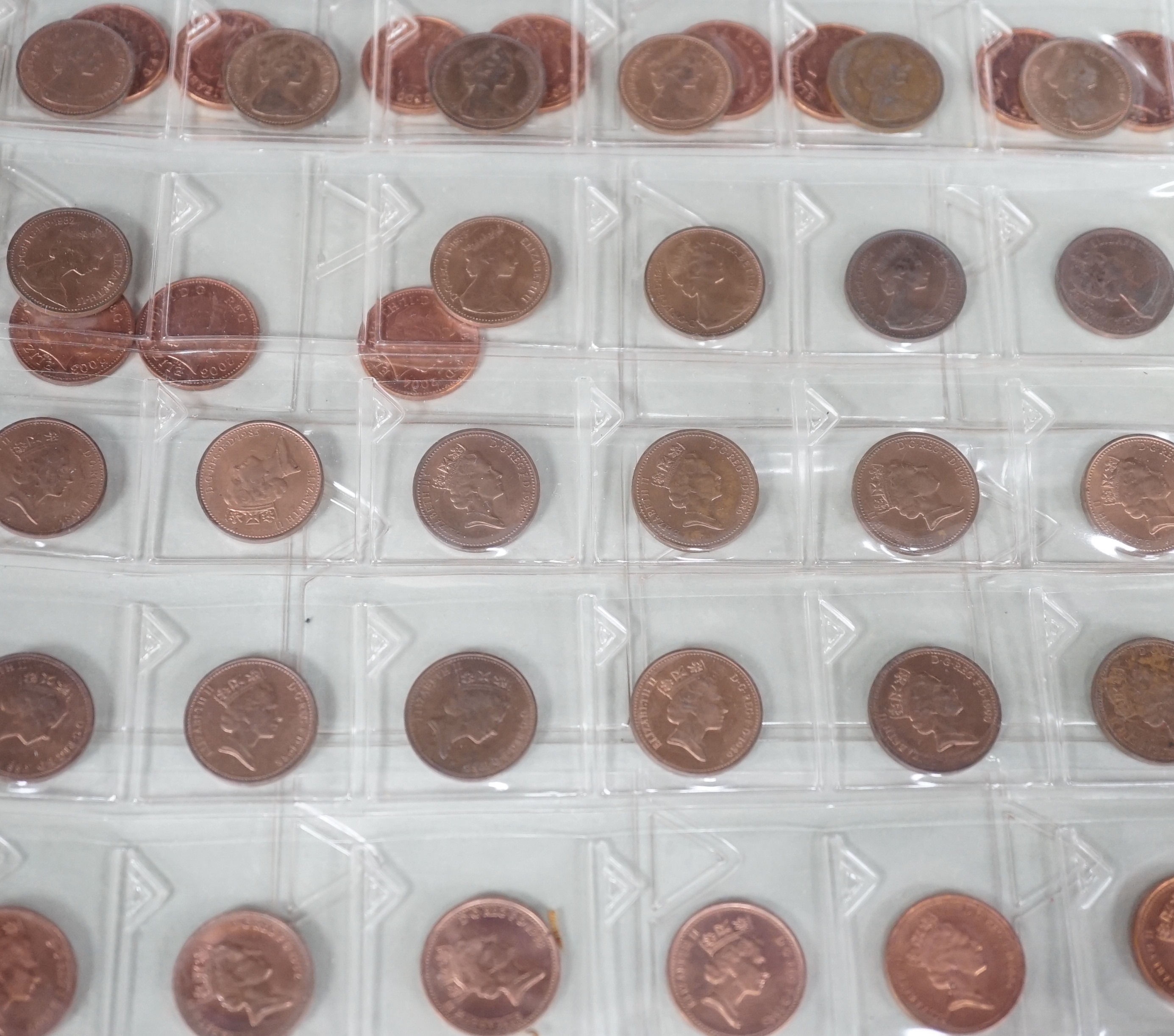 An album of British half pennies and farthings, Charles II to QEII, half pennies include 1730 F, 1806 UNC, 1827 GVD, 1877 lustrous UNC, Farthings including 1788 VF, 1799 EF, 1821 EF and decimal pennies